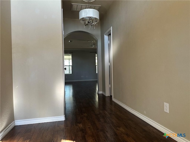 hall featuring a notable chandelier and dark hardwood / wood-style floors