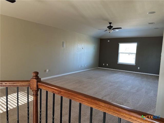 carpeted empty room with ceiling fan