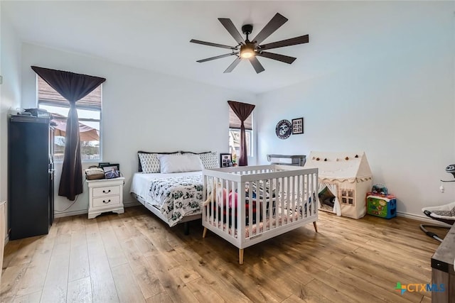 bedroom featuring wood-type flooring and ceiling fan