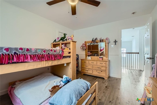 bedroom with baseboards, a ceiling fan, and wood finished floors