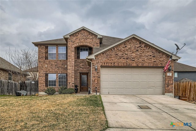 traditional-style house featuring concrete driveway, brick siding, an attached garage, and fence