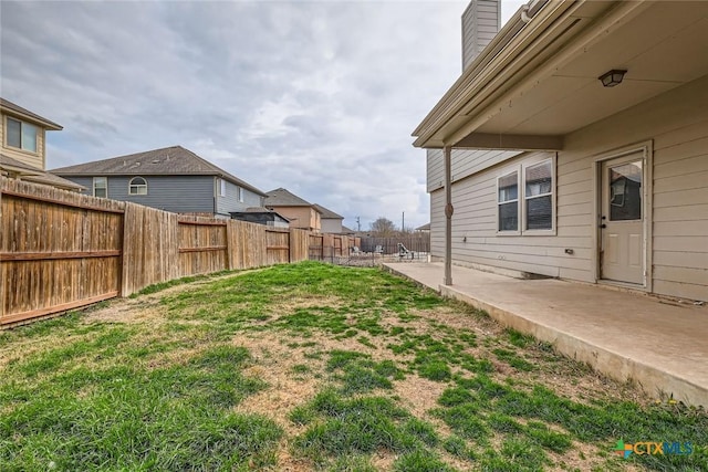 view of yard with a fenced backyard and a patio