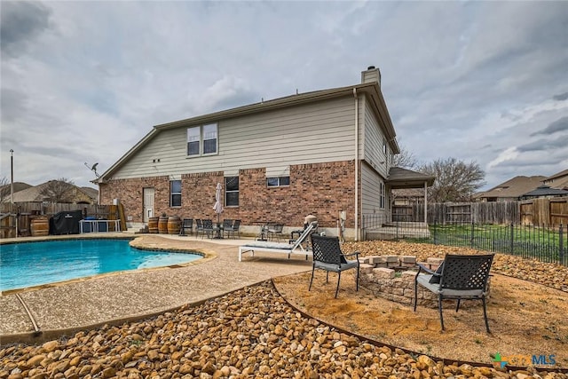 view of swimming pool featuring a patio, fence, and a fenced in pool