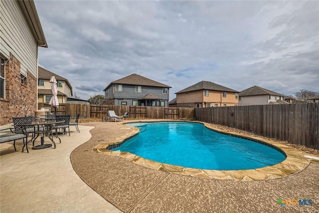 view of pool featuring a fenced backyard, a fenced in pool, and a patio