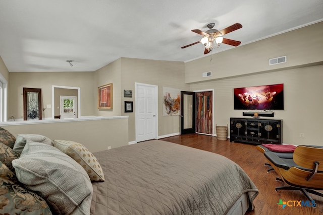 bedroom featuring hardwood / wood-style floors, vaulted ceiling, and ceiling fan