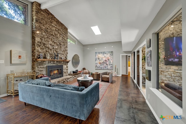 living room with a fireplace, beam ceiling, a healthy amount of sunlight, and dark hardwood / wood-style floors