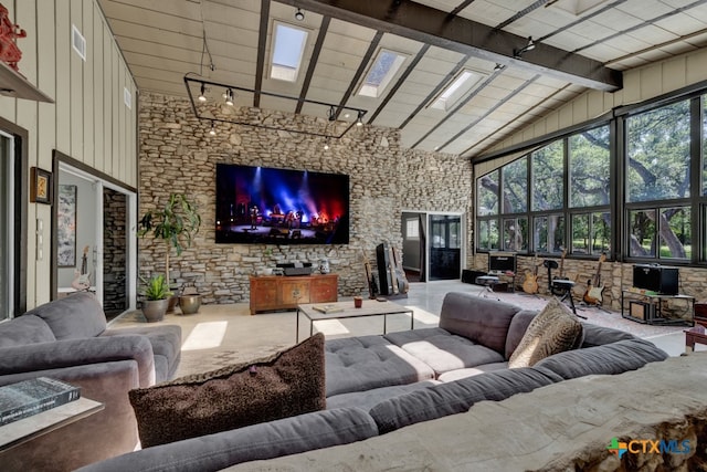 living room featuring high vaulted ceiling, a skylight, wood ceiling, and beam ceiling