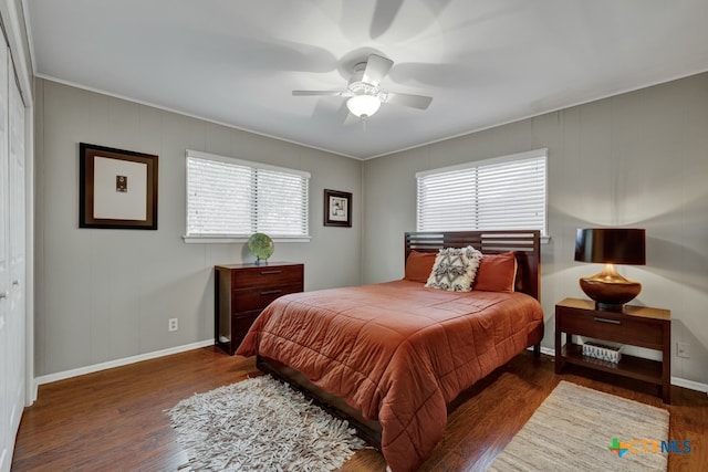 bedroom featuring a closet, ceiling fan, and dark hardwood / wood-style floors