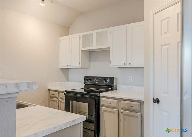 kitchen featuring white cabinets, black range with electric stovetop, and vaulted ceiling