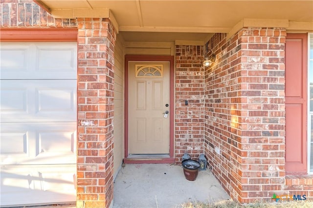 view of exterior entry featuring a garage