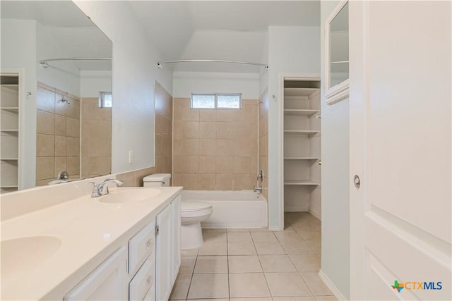 full bathroom with toilet, vanity, tiled shower / bath combo, and tile patterned flooring