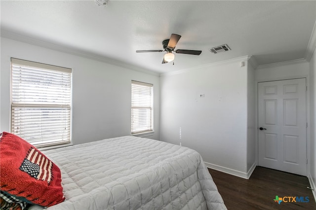 bedroom with ceiling fan, crown molding, and dark hardwood / wood-style flooring