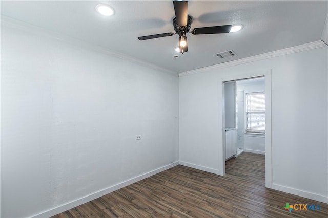 spare room featuring dark wood-type flooring, ceiling fan, and ornamental molding