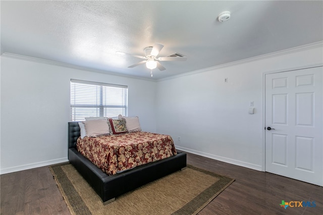 bedroom featuring a textured ceiling, dark hardwood / wood-style flooring, ceiling fan, and crown molding