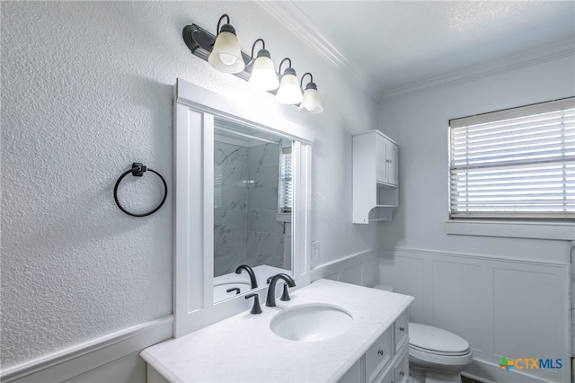 bathroom featuring tiled shower, toilet, vanity, and crown molding