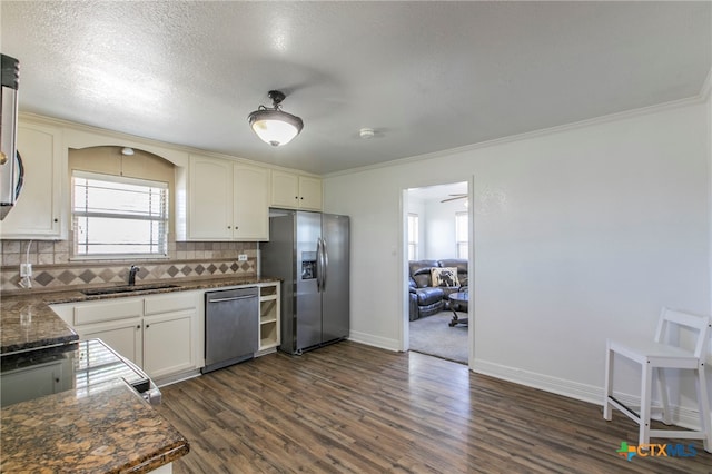 kitchen featuring sink, dark hardwood / wood-style floors, crown molding, backsplash, and appliances with stainless steel finishes