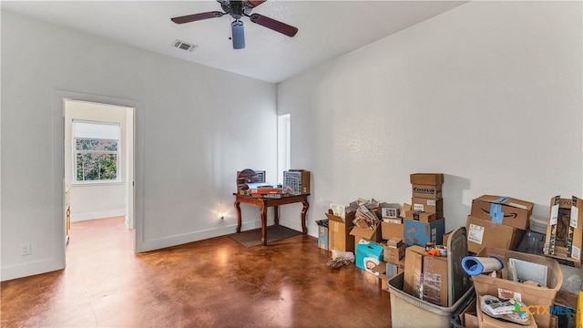 misc room featuring ceiling fan and concrete floors