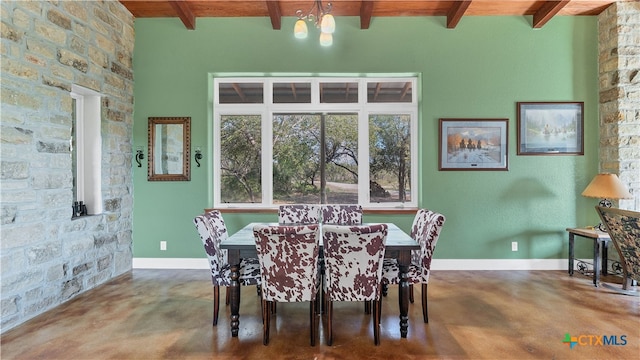 dining area with concrete flooring, beamed ceiling, wooden ceiling, and an inviting chandelier