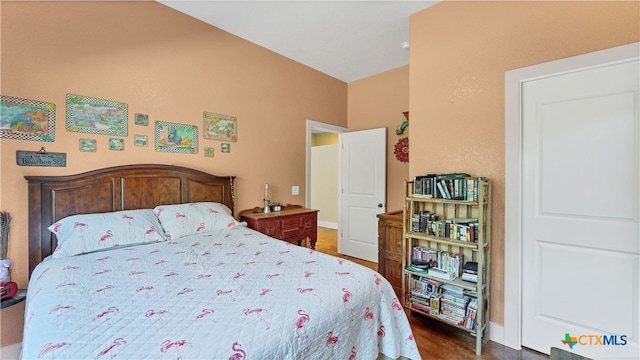 bedroom with dark hardwood / wood-style flooring