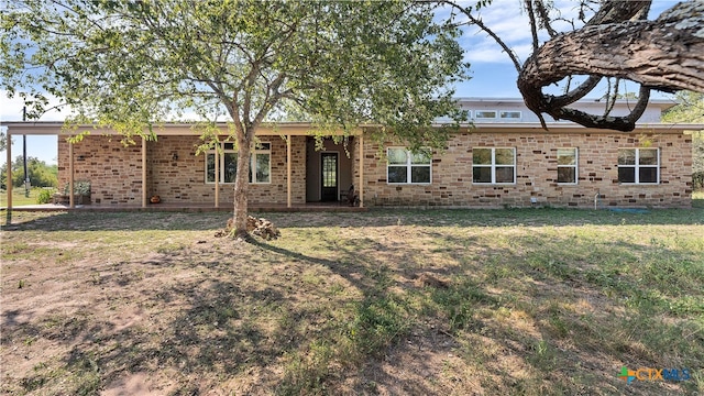 rear view of house with a lawn