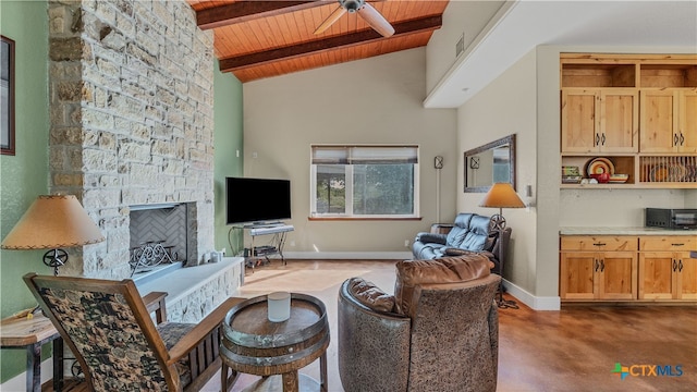 living room featuring a stone fireplace, wooden ceiling, high vaulted ceiling, beamed ceiling, and ceiling fan