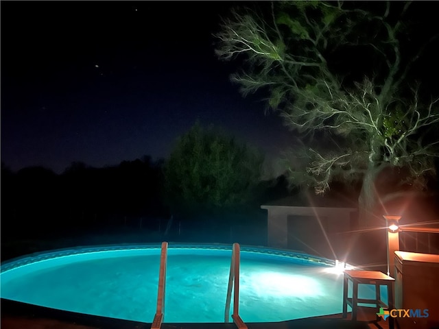 view of pool at night