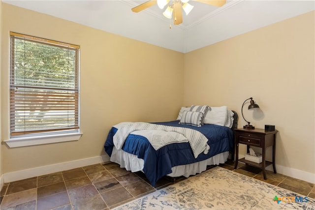 bedroom with ceiling fan, ornamental molding, and lofted ceiling