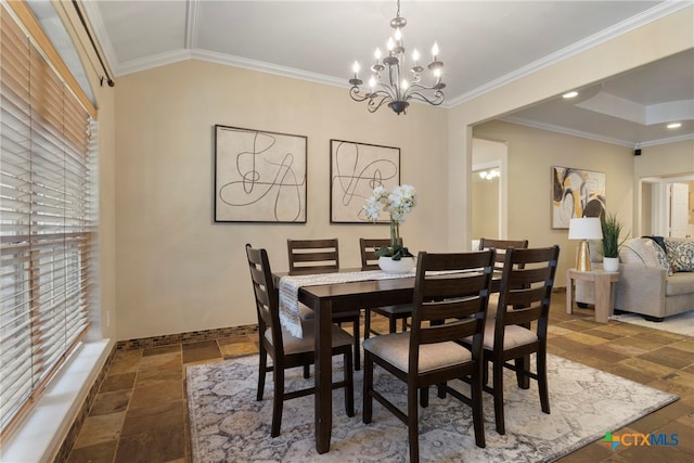 dining space with crown molding and an inviting chandelier