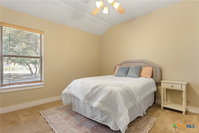 carpeted bedroom with ceiling fan and vaulted ceiling