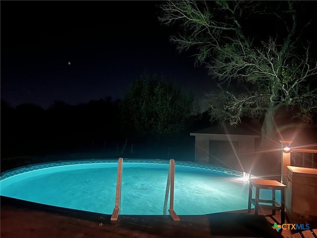 view of pool at night