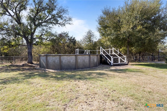 view of yard with a fenced in pool