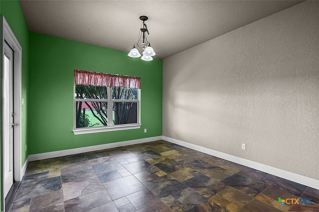 unfurnished dining area with a notable chandelier