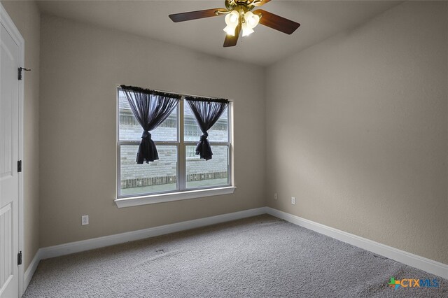 unfurnished room with carpet and ceiling fan