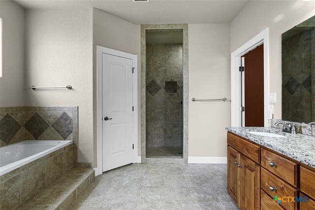 bathroom with vanity and independent shower and bath