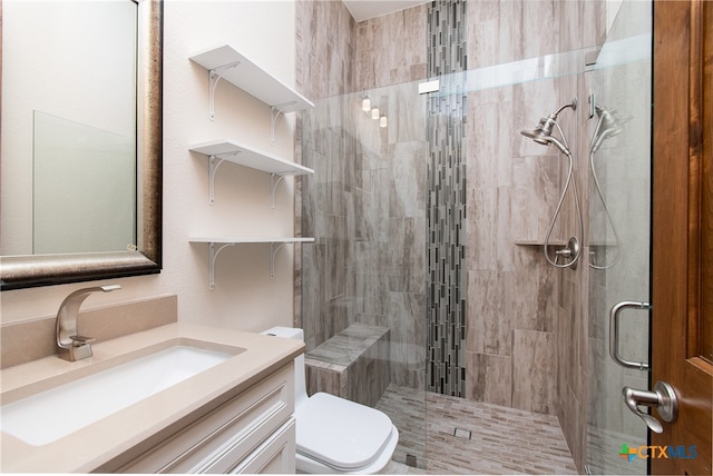 bathroom with vanity, toilet, and an enclosed shower