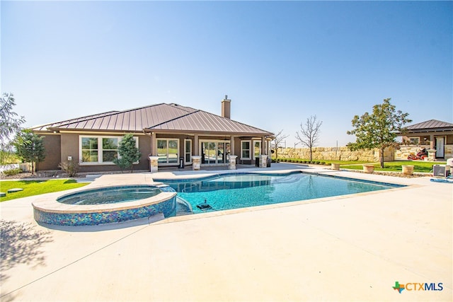 view of pool with a patio and an in ground hot tub