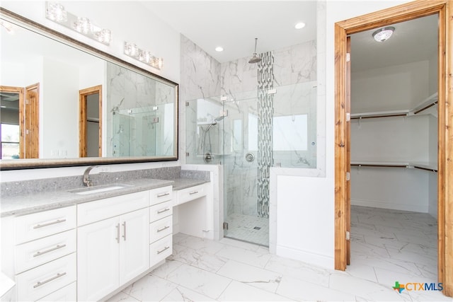 bathroom with vanity and a shower with door