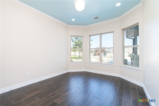 empty room with ornamental molding and dark hardwood / wood-style floors