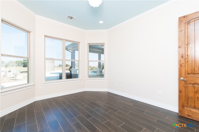 spare room with crown molding and dark hardwood / wood-style flooring