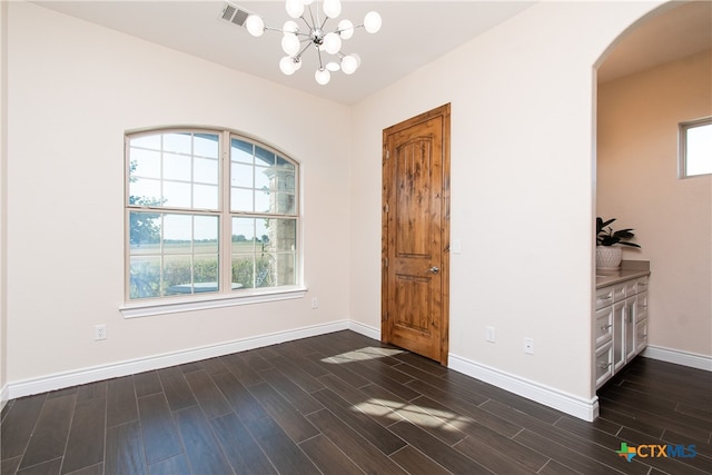 interior space featuring dark hardwood / wood-style floors and a notable chandelier