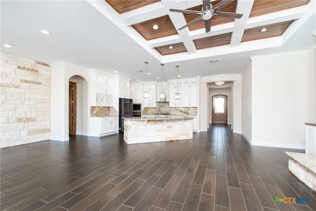 kitchen featuring backsplash, hanging light fixtures, white cabinets, dark wood-type flooring, and a center island