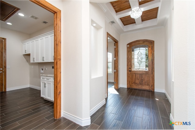 foyer with ornamental molding and dark wood-type flooring