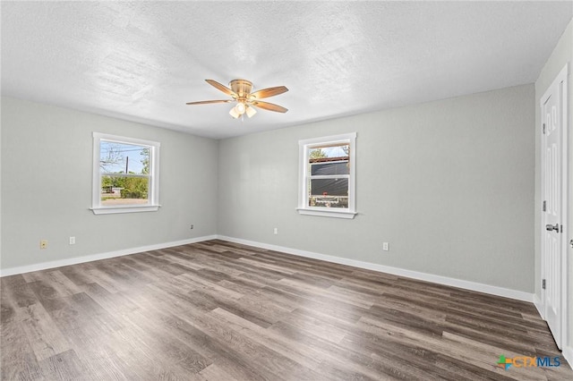unfurnished bedroom featuring baseboards, a ceiling fan, a textured ceiling, and wood finished floors