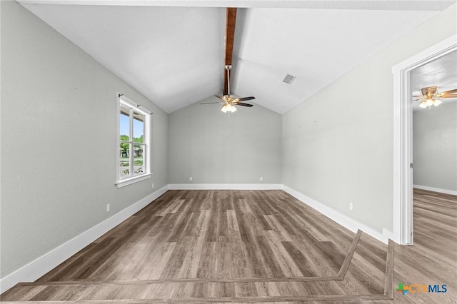 spare room featuring ceiling fan, visible vents, wood finished floors, baseboards, and lofted ceiling with beams