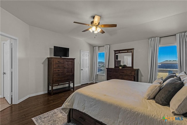 bedroom with dark wood-style flooring, baseboards, multiple windows, and ceiling fan