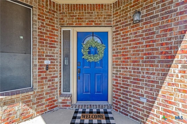 entrance to property with brick siding