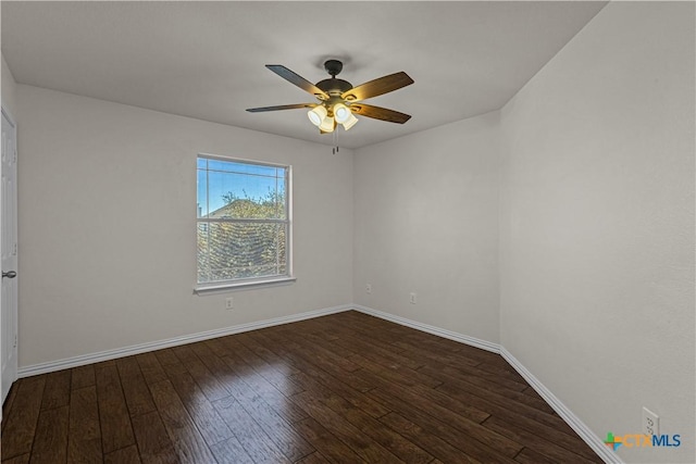 empty room with dark wood-style floors, baseboards, and ceiling fan
