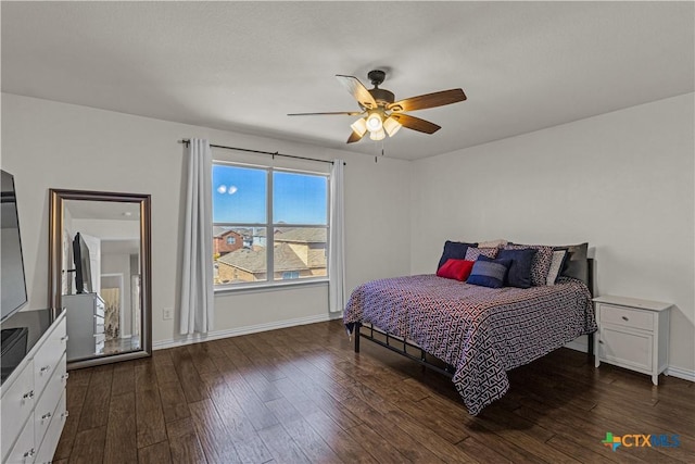 bedroom featuring dark wood-style flooring, baseboards, and a ceiling fan