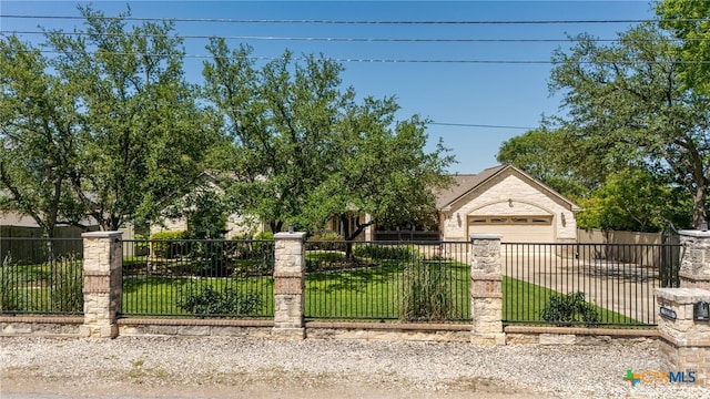 view of property hidden behind natural elements featuring driveway