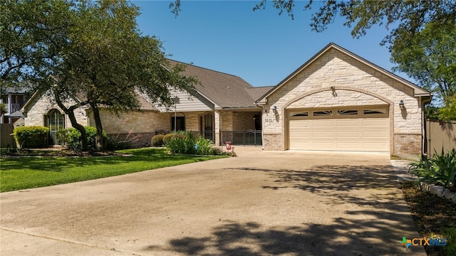 view of front facade featuring an attached garage, driveway, and stone siding